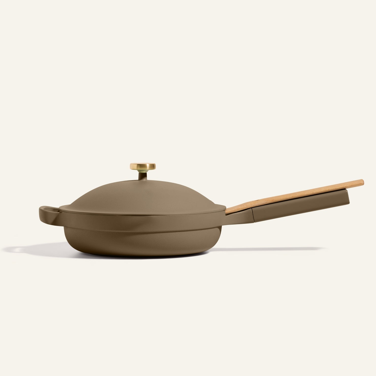 The Always Pan 2.0, a matte olive green nonstick frying pan with a lid plus wooden handle and knob, is shown on a plain light background—an essential from our bestselling cookware collection.
