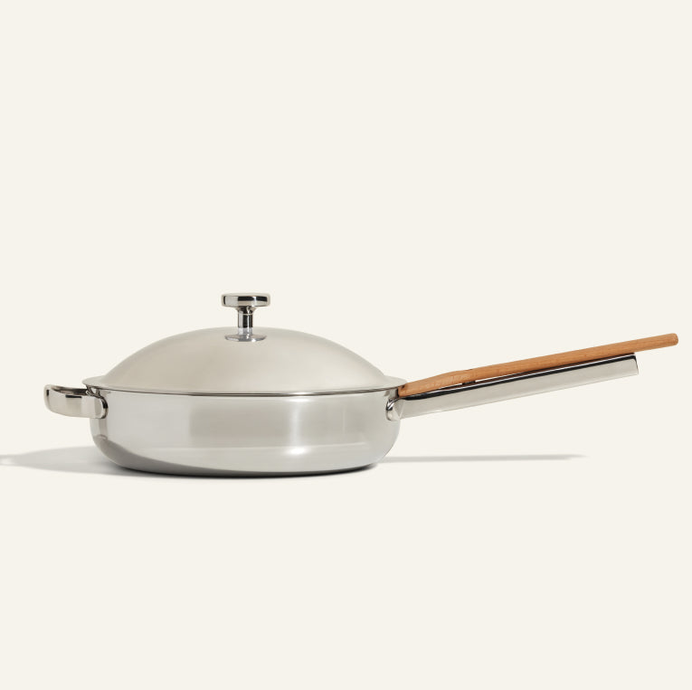 The Titanium Always Pan Pro features a domed lid, long wooden handle, short side handle, and no-coating nonstick technology—all showcased against a plain light background.