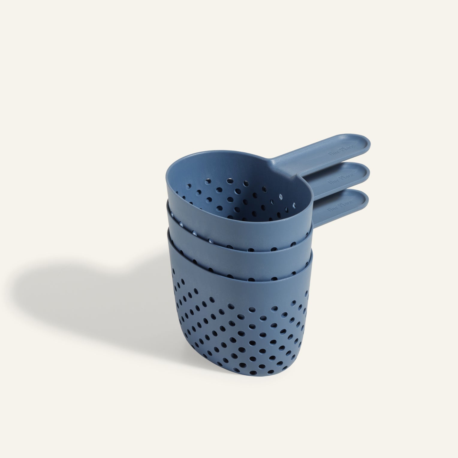 Three blue plastic Cooker Cups with holes, stacked on a light background—perfect for multi-cooking or pairing with your Perfect Pot to cook three dishes at once.