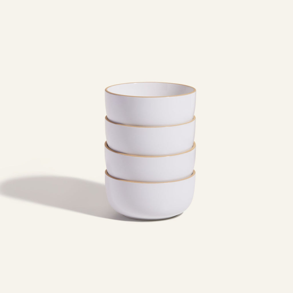 Four Soup Bowls with white ceramic bodies and light brown rims are stacked together against a plain, light background, highlighting a stylish addition to your tableware collection.