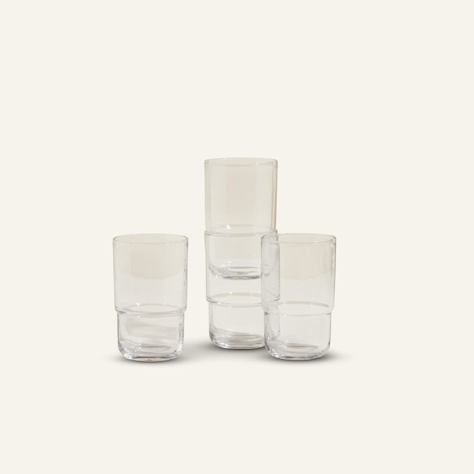 Four Tall Night + Day Glasses are arranged against a light background, with two 16 oz tumblers stacked and two standing separately in a minimalistic stackable display.