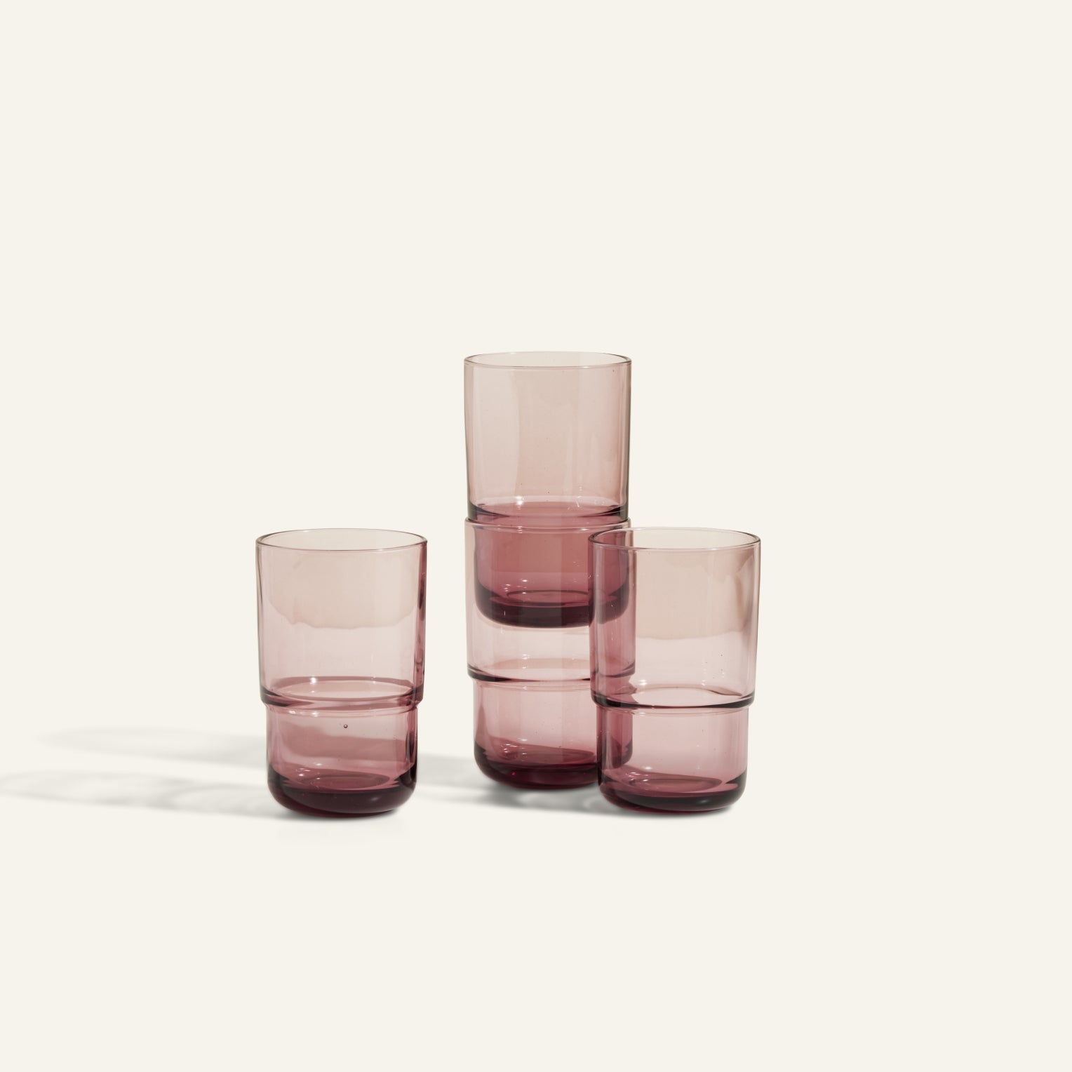 Four translucent purple Tall Night + Day Glasses, each 16 oz, are arranged with two stacked in the center and two standing separately on either side against a plain light background.