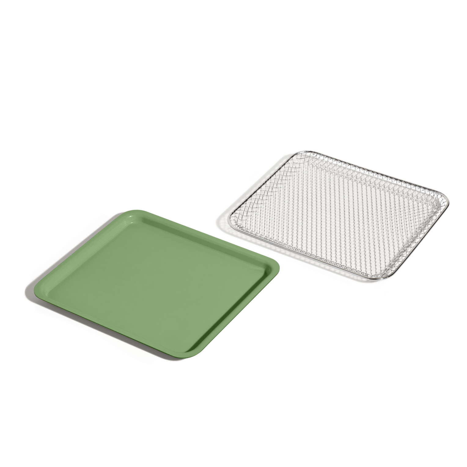 The Wonder Oven Essentials Kit, featuring a green rectangular tray and a silver wire mesh tray, is displayed side by side on a white background—perfect for doubling recipes or organizing extra components for your Wonder Oven.