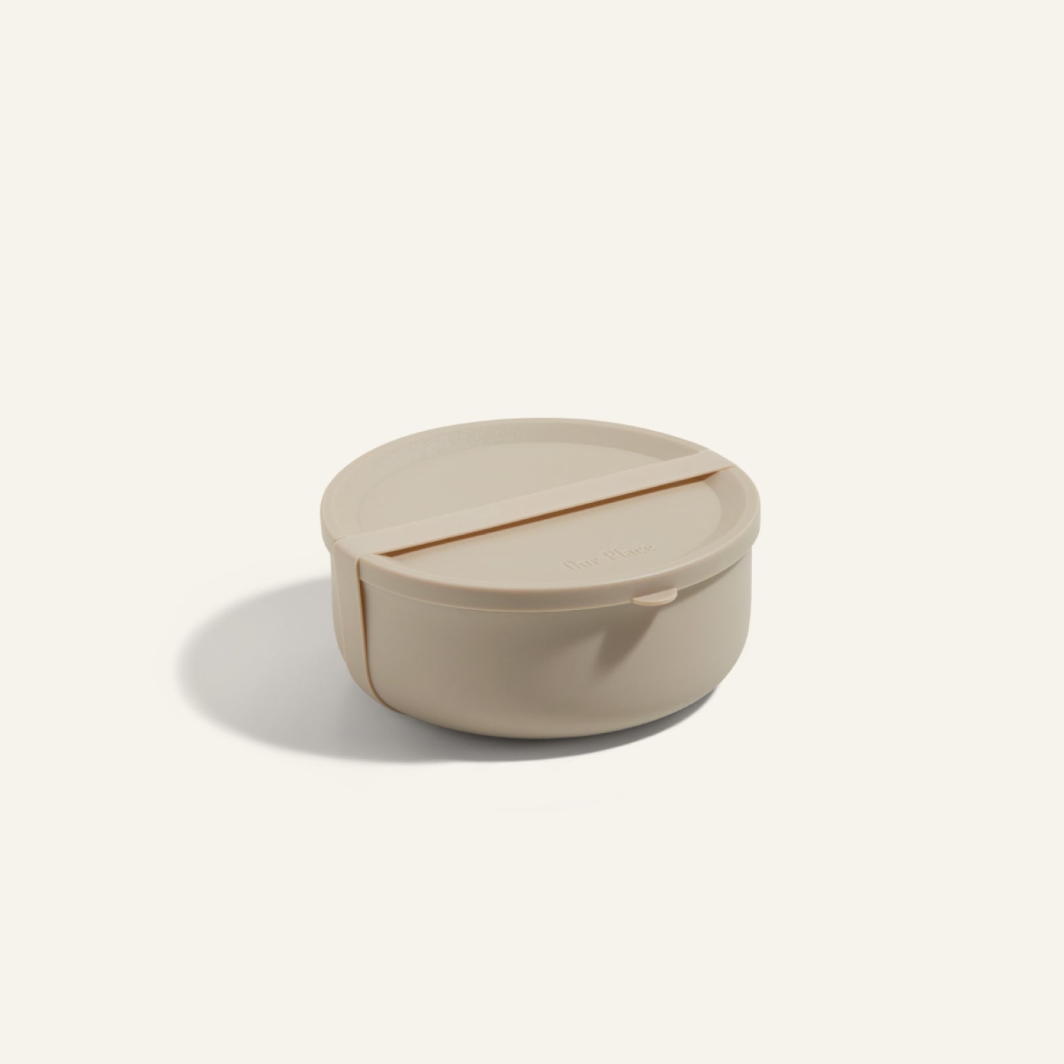 The Wander Bowl is a round, beige ceramic bowl with a fitted lid, shown on a plain light background—ideal as a microwave-safe lunch container.