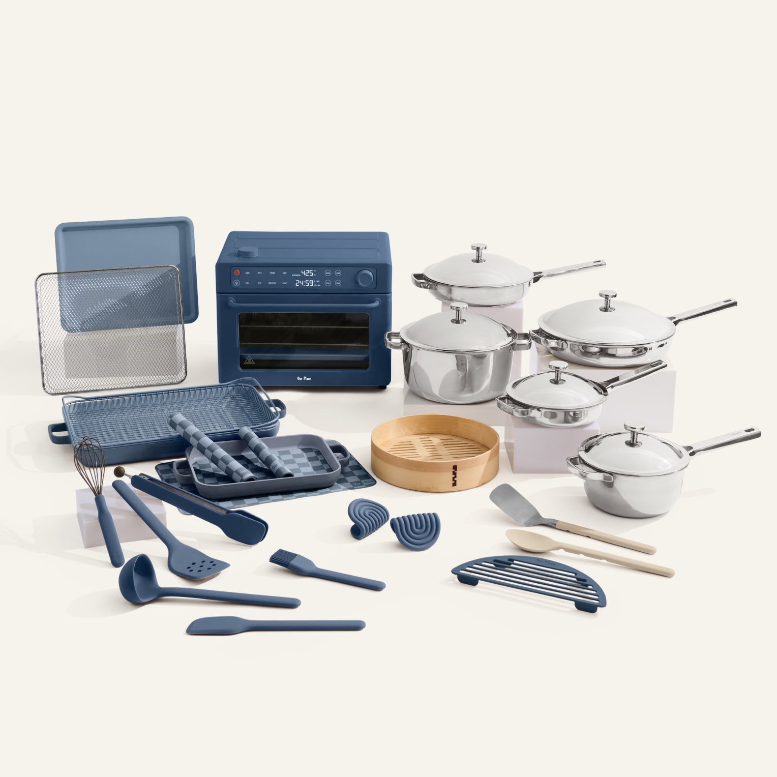 Collection of kitchen cookware and utensils including pots, pans, and tools on a white background