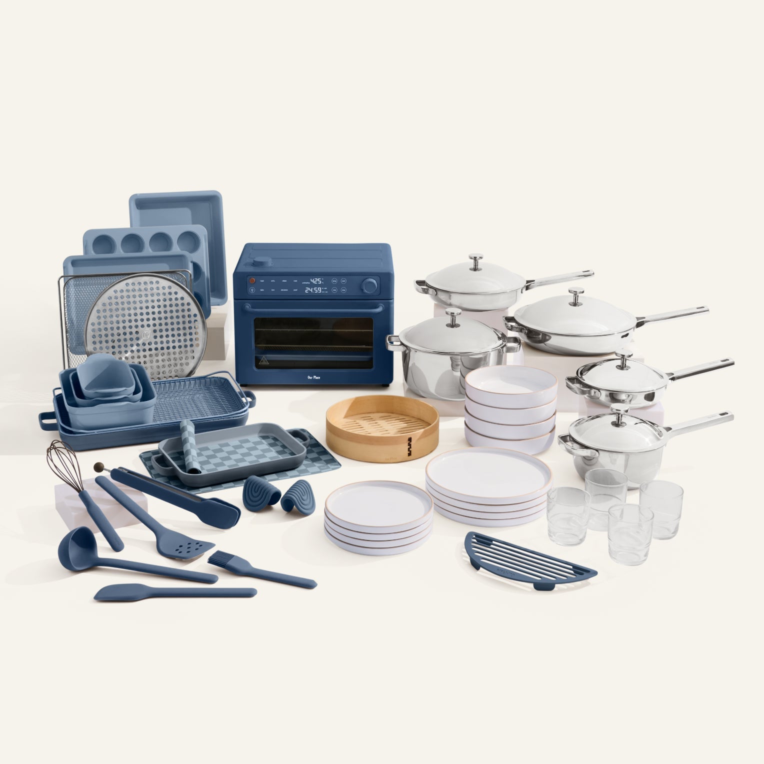 Collection of kitchenware including pots, pans, utensils, and cookware on a white background