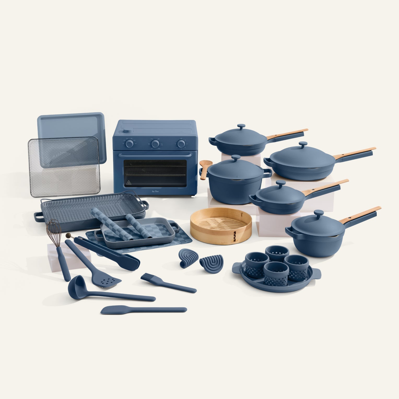 Set of blue cookware and kitchen utensils on a white background