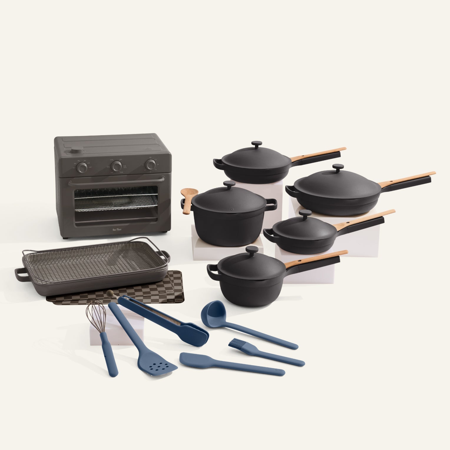 Set of black cookware including pots, pans, and utensils on a white background