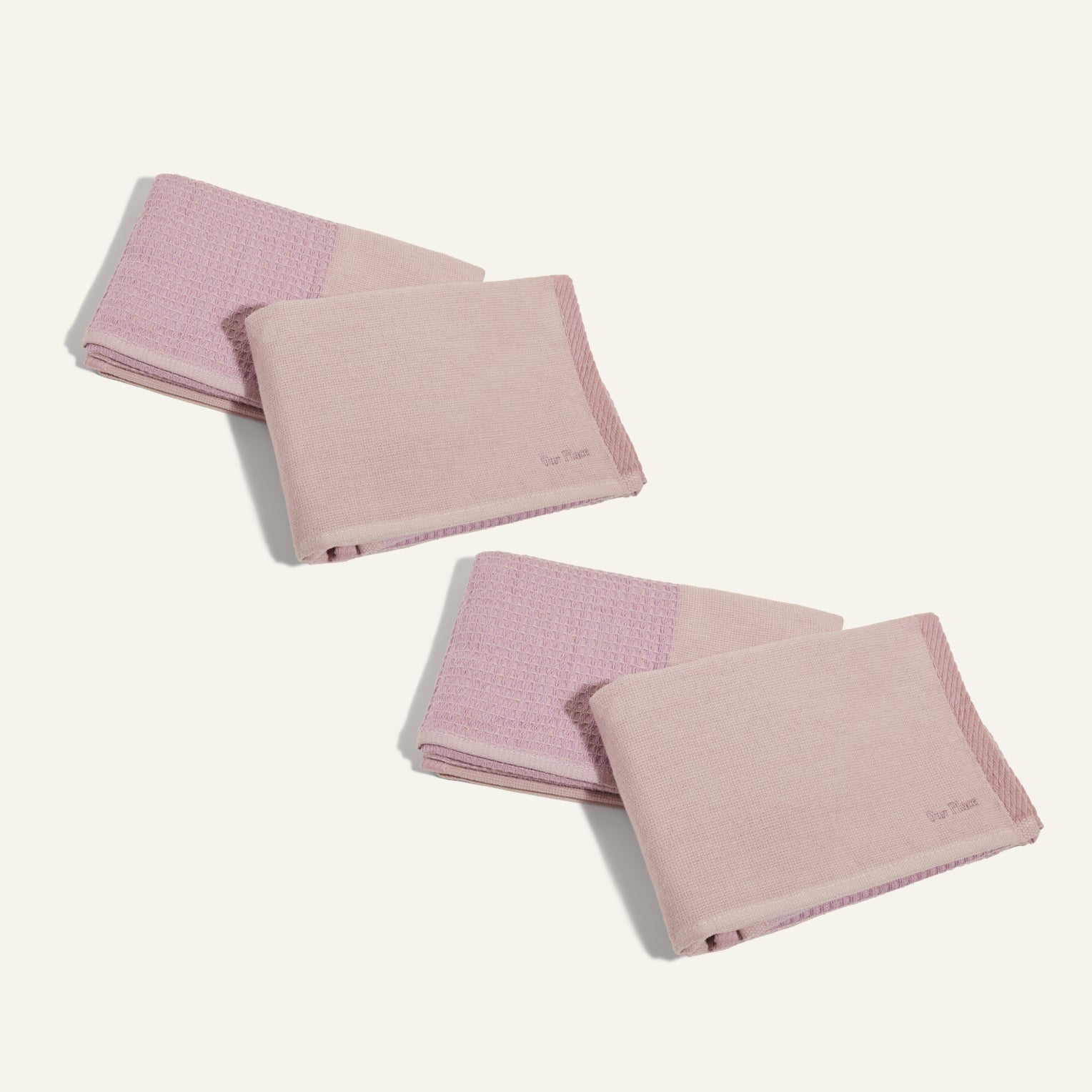 Four folded Double Dish Towels in pink, with both textured and smooth sections, are arranged on a plain light background.