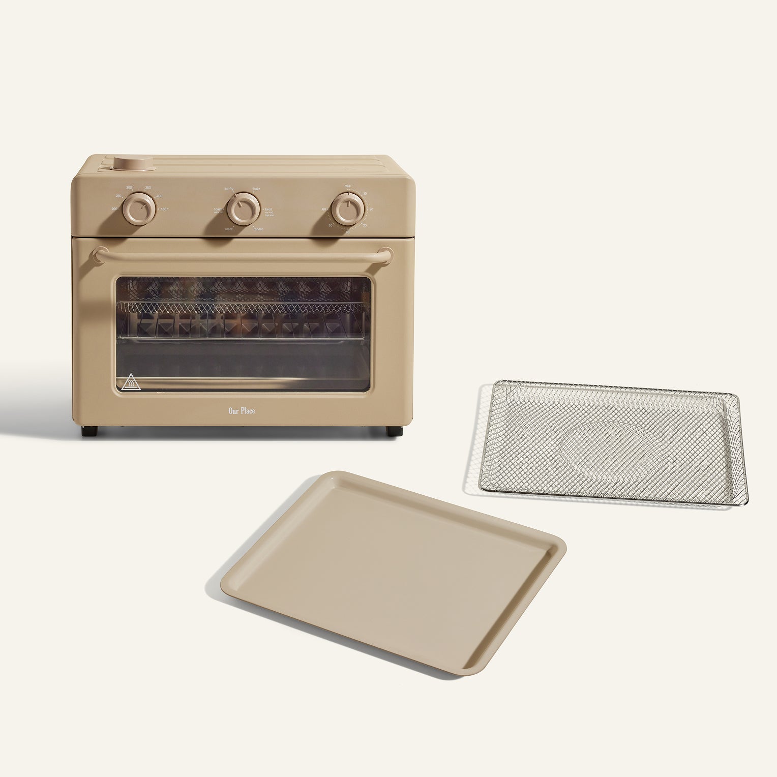 The Large Wonder Oven + Large Wonder Oven Essentials Kit in beige features three dials and includes a metal wire rack and matching beige baking tray, all displayed on a light background.