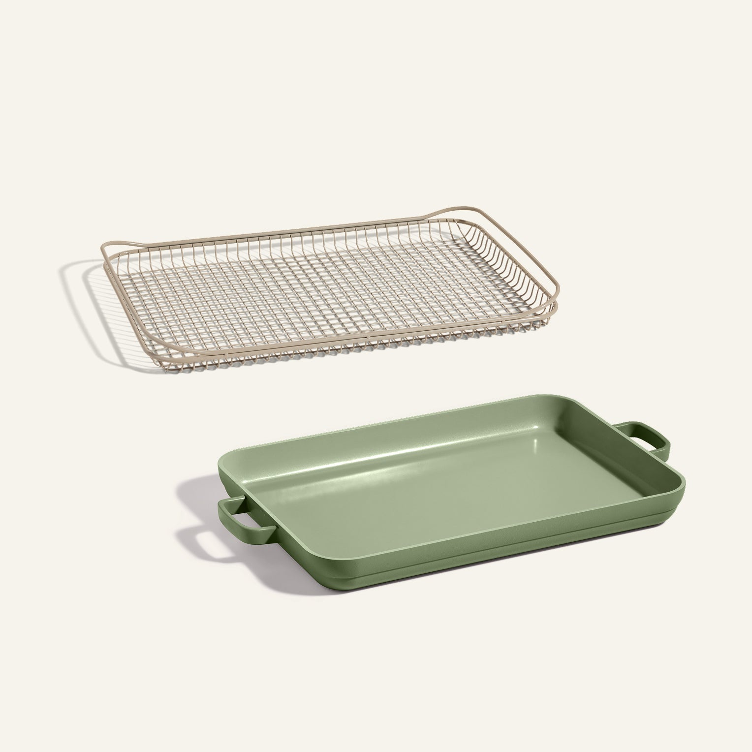 The Oven Rack + Griddle Pan set, featuring a green rectangular pan with handles and a beige wire rack, is displayed on a light background.