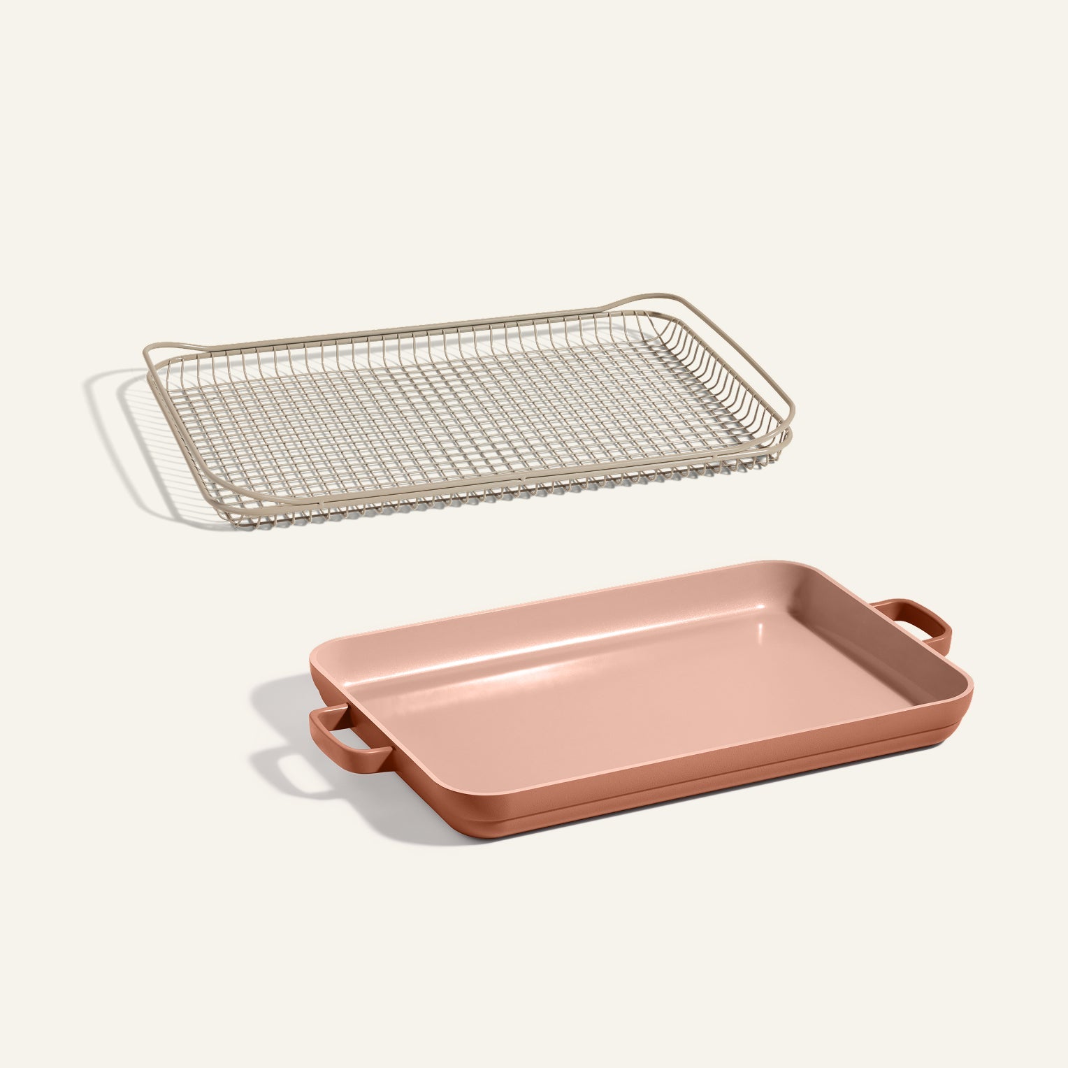 An Oven Rack and a pink Griddle Pan with handles are displayed together on a neutral background.