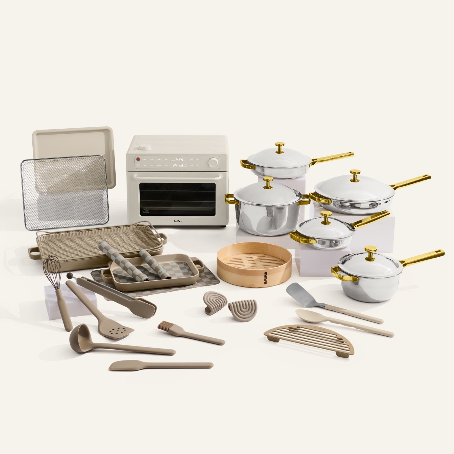 Collection of kitchenware including pots, pans, and utensils on a white background