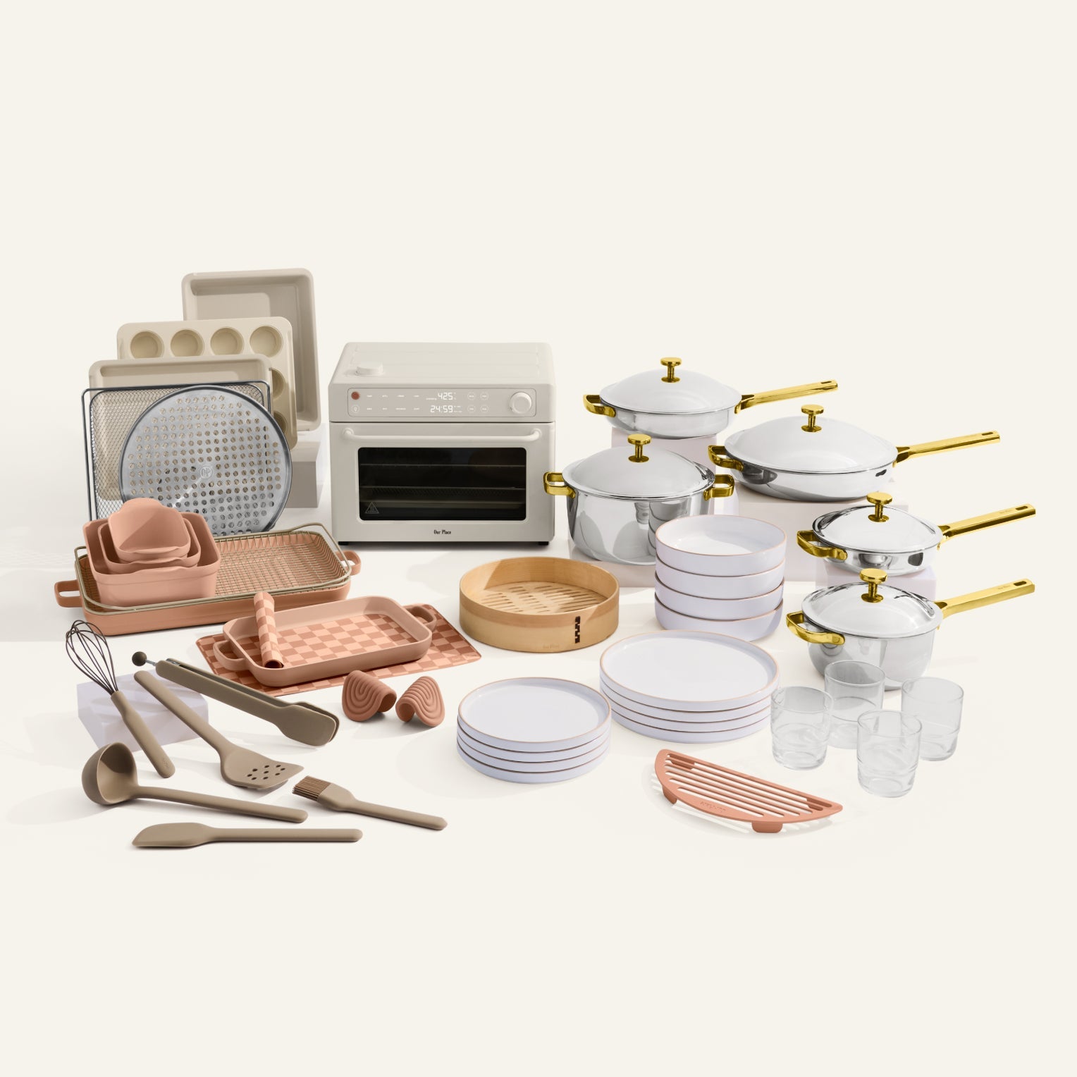 Collection of kitchenware including pots, pans, and utensils on a white background
