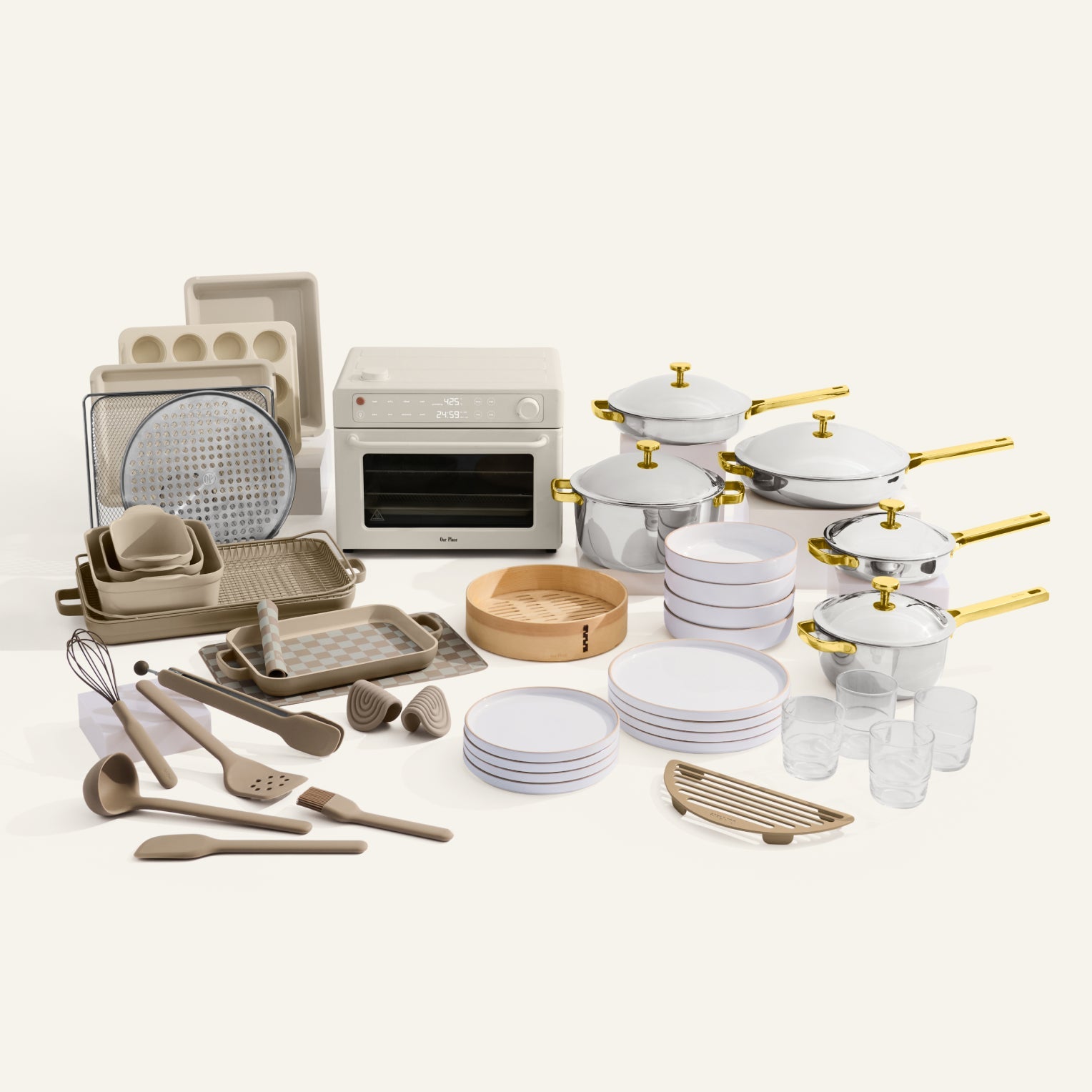 Collection of kitchenware including pots, pans, and utensils on a white background