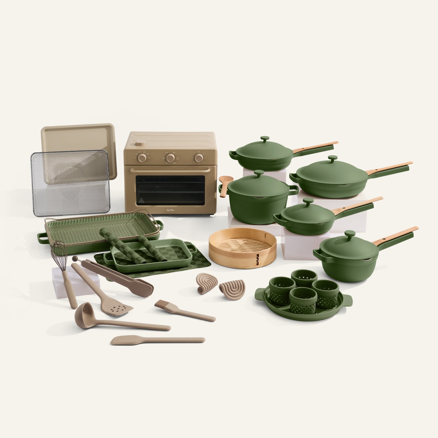 Set of green cookware and kitchen utensils on a white background
