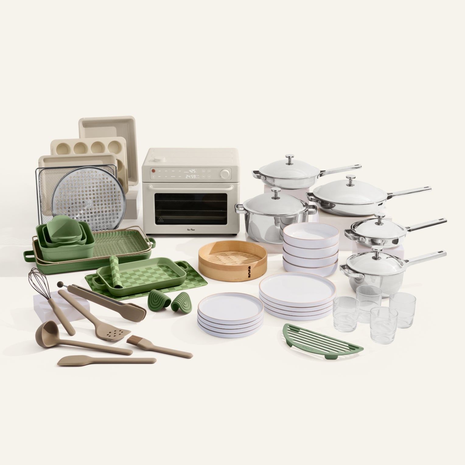 Collection of kitchenware including pots, pans, utensils, and cookware on a white background