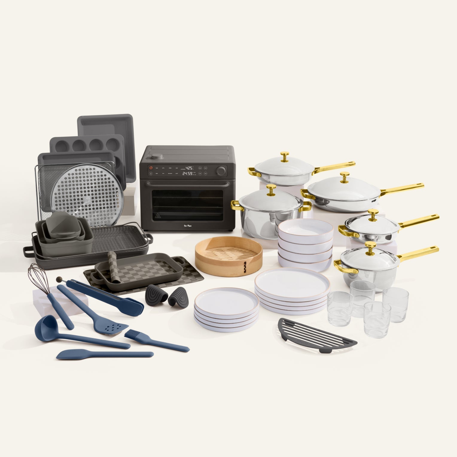 Collection of kitchenware including cookware, bakeware, and utensils on a white background