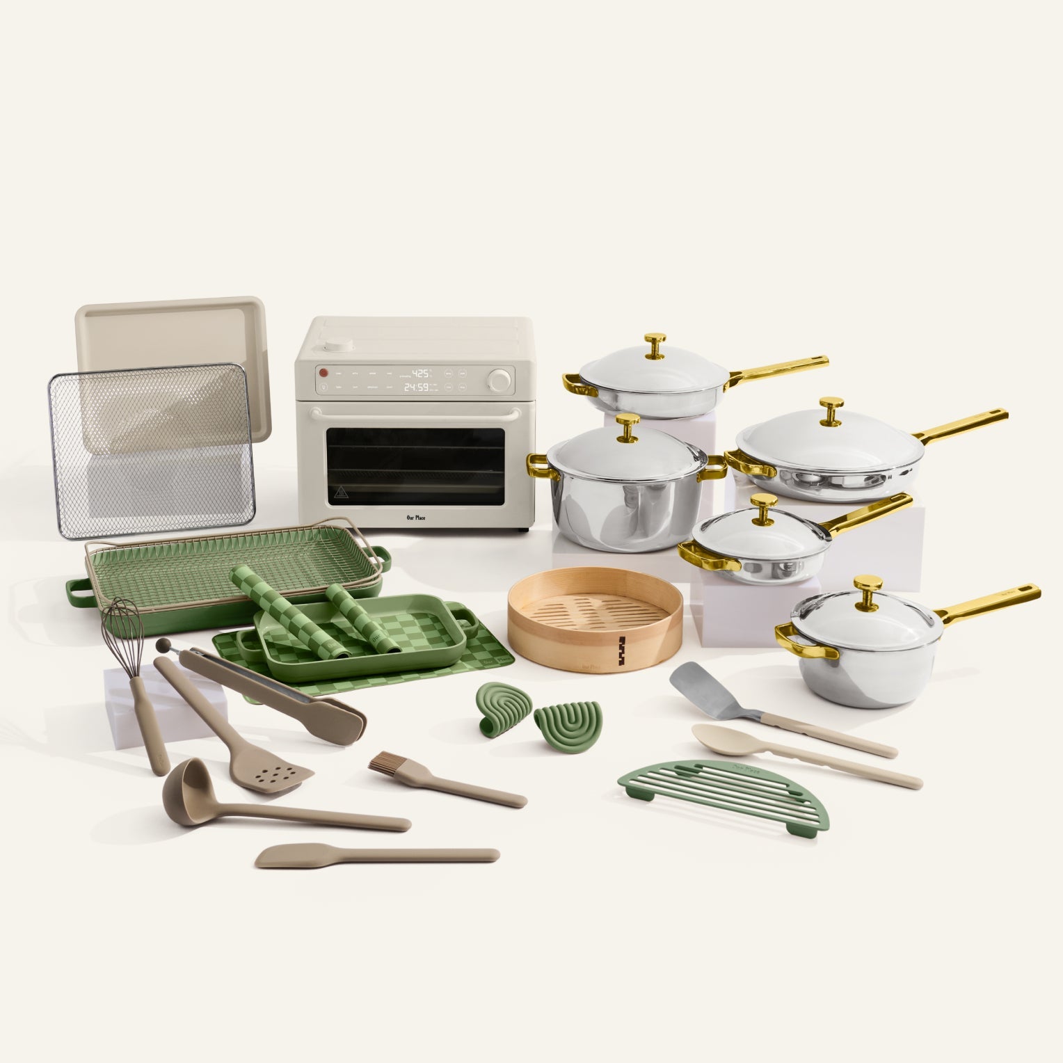 Collection of kitchenware including pots, pans, and utensils on a white background