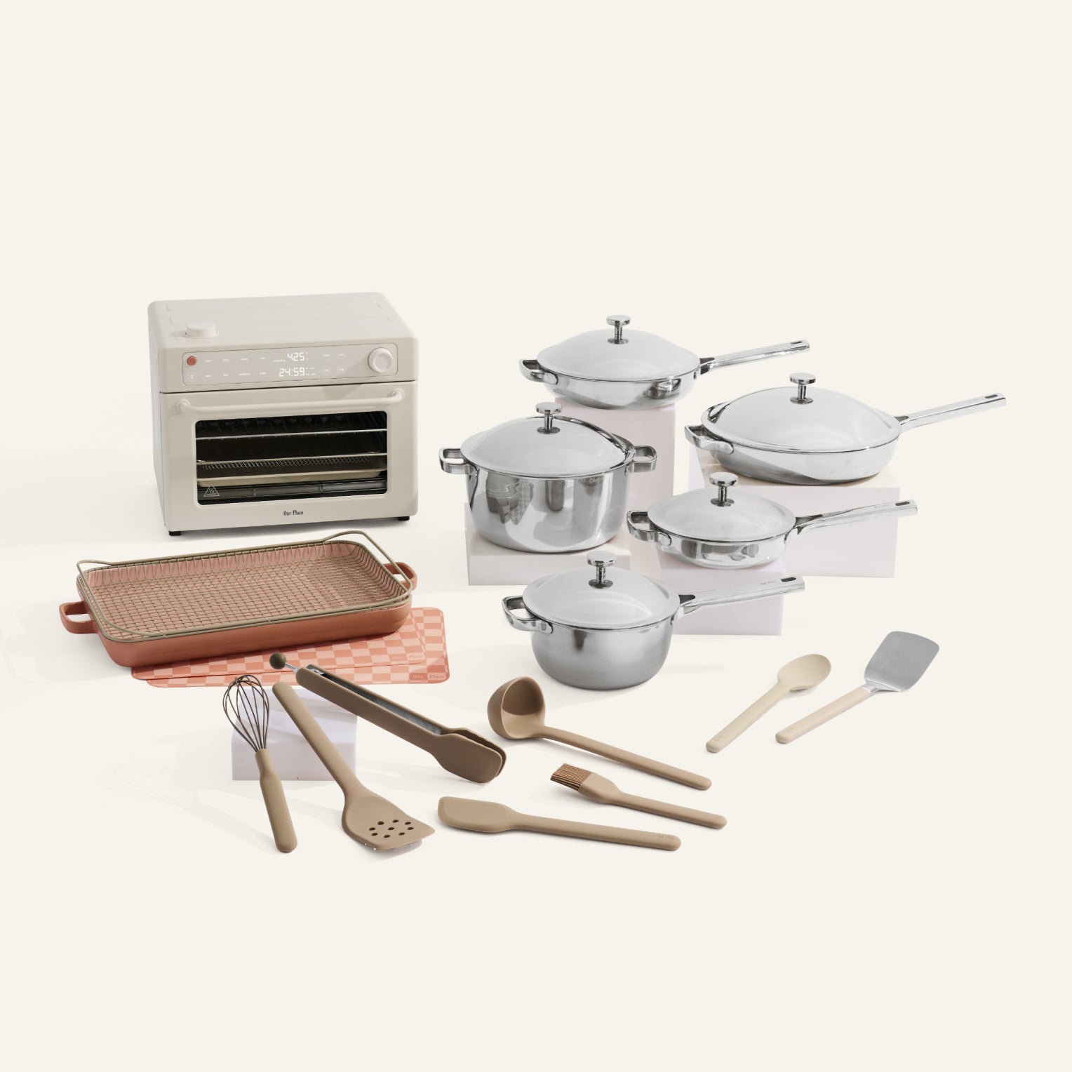 Kitchen appliance set with pots, pans, and utensils on a white background