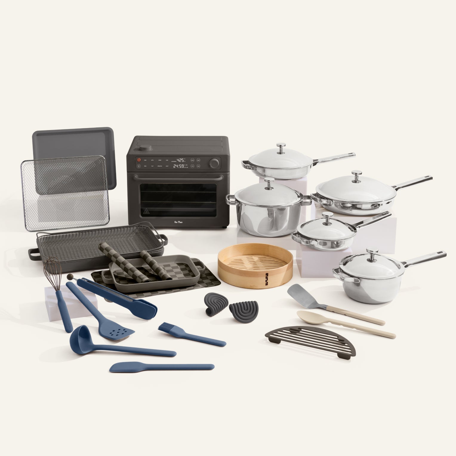 Collection of kitchen appliances and utensils including pots, pans, and cookware on a white background.