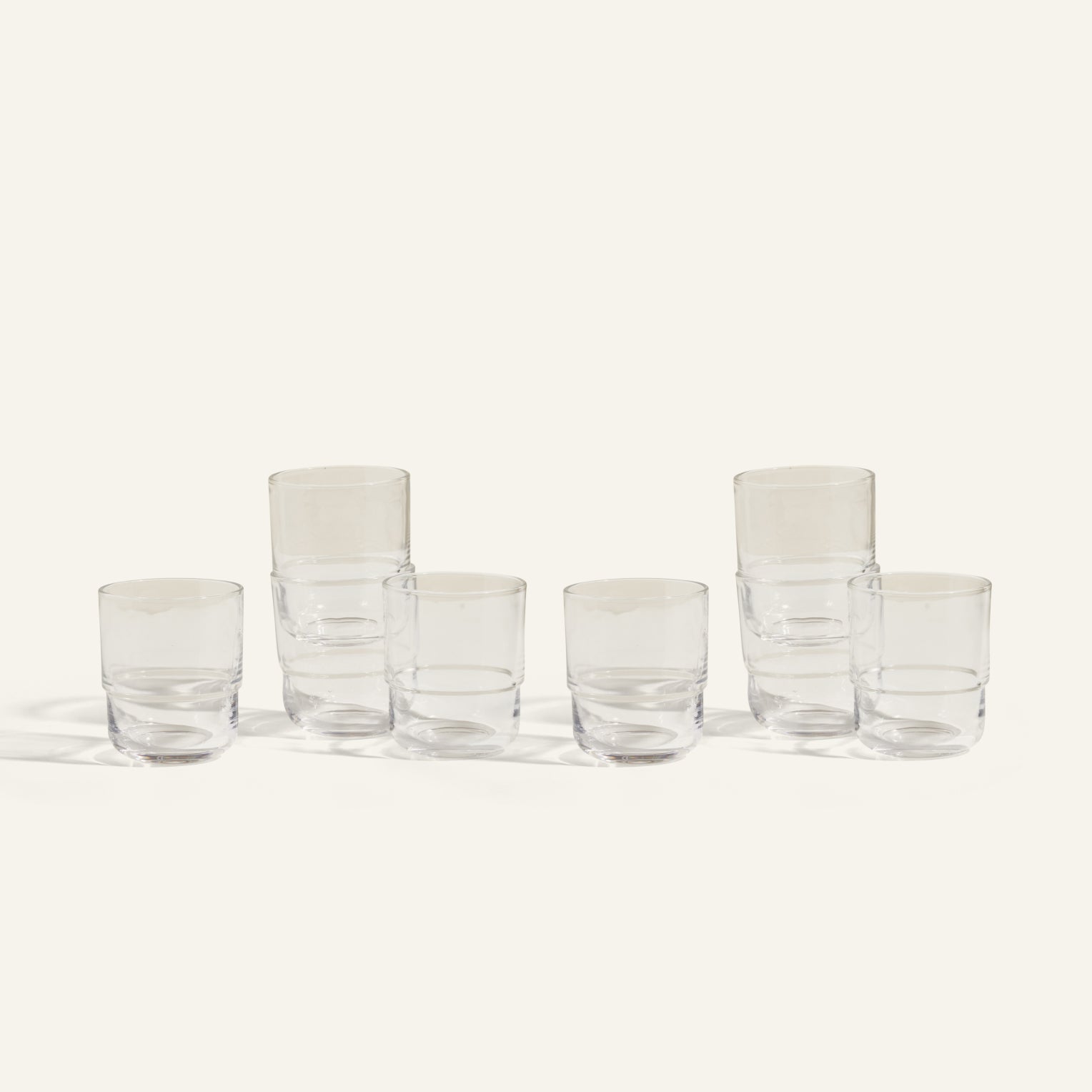 Six clear, empty Short Night + Day Glasses are arranged in two rows on a light background; three are stacked in pairs and three stand alone, highlighting these versatile handmade tumblers perfect for any occasion.