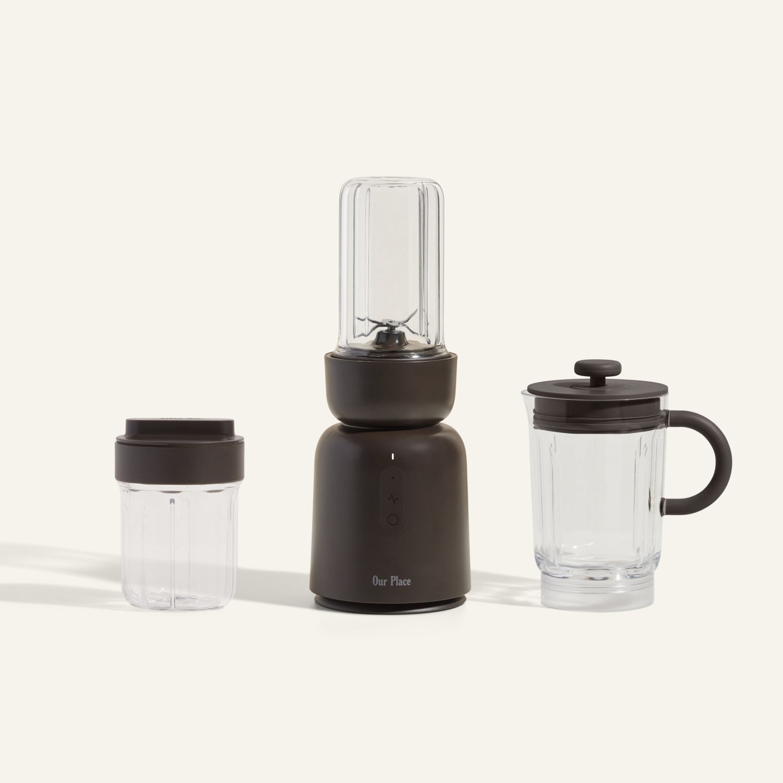 The Splendor Blender + Splendor Blender Everything Kit, in black and clear, features a countertop blender with an attached blending jar and includes two extra clear jars—one with a lid and one with a handle and spout—on a light background.