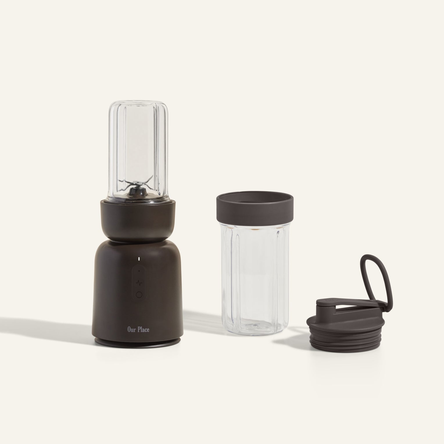 The Splendor Blender + Splendor Blender Personal Kit includes a compact dark blender with a blending jar, an extra jar with lid, and a separate travel lid, all shown on a light background.