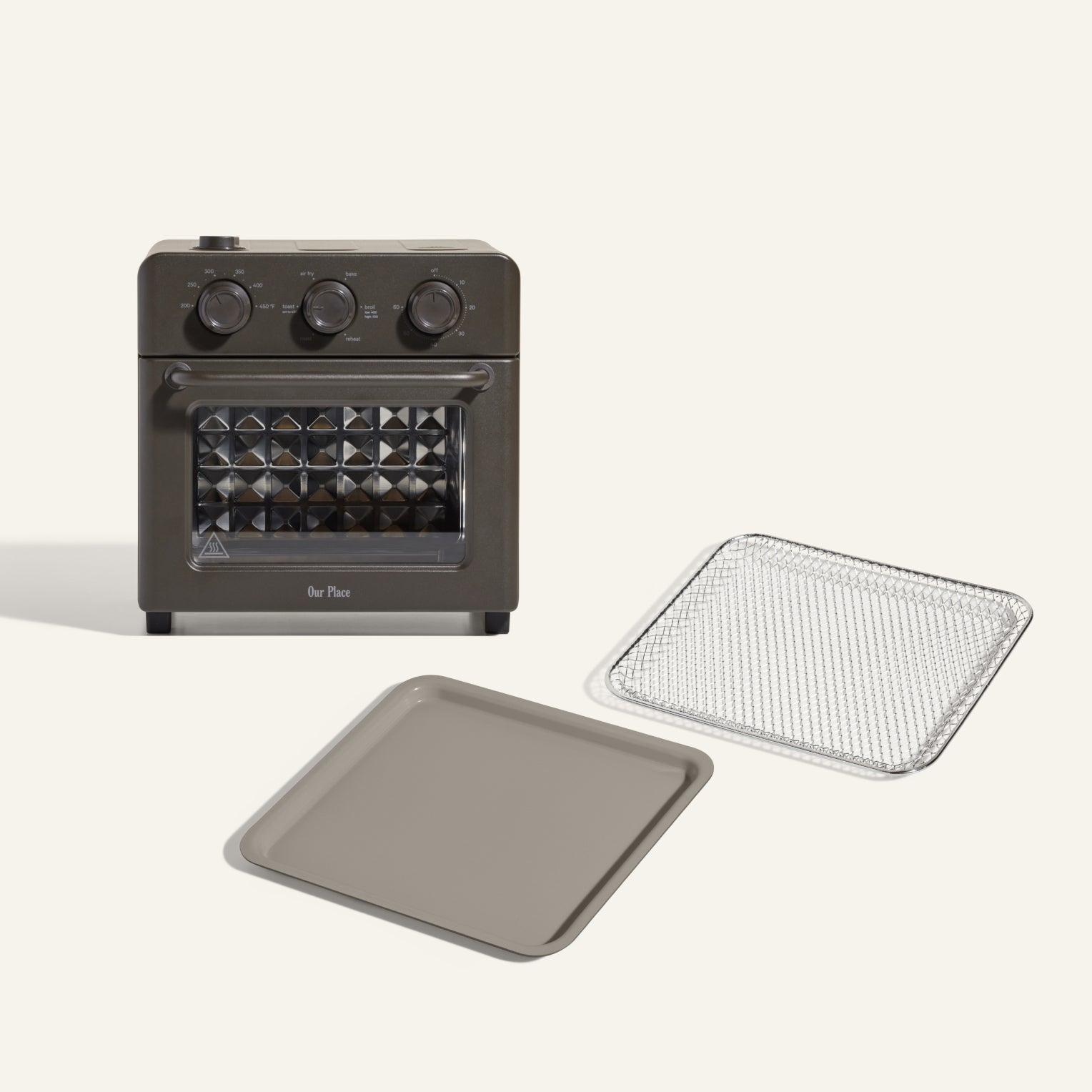 The Wonder Oven + Wonder Oven Essentials Kit includes a countertop oven with three control knobs, shown with a metal baking tray and mesh tray, displayed on a plain background.