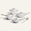 The VIP Titanium Pro Complete Cookware Set features four white titanium pieces with lids and two utensils, elegantly displayed on a light background—combining high performance and style for any kitchen.