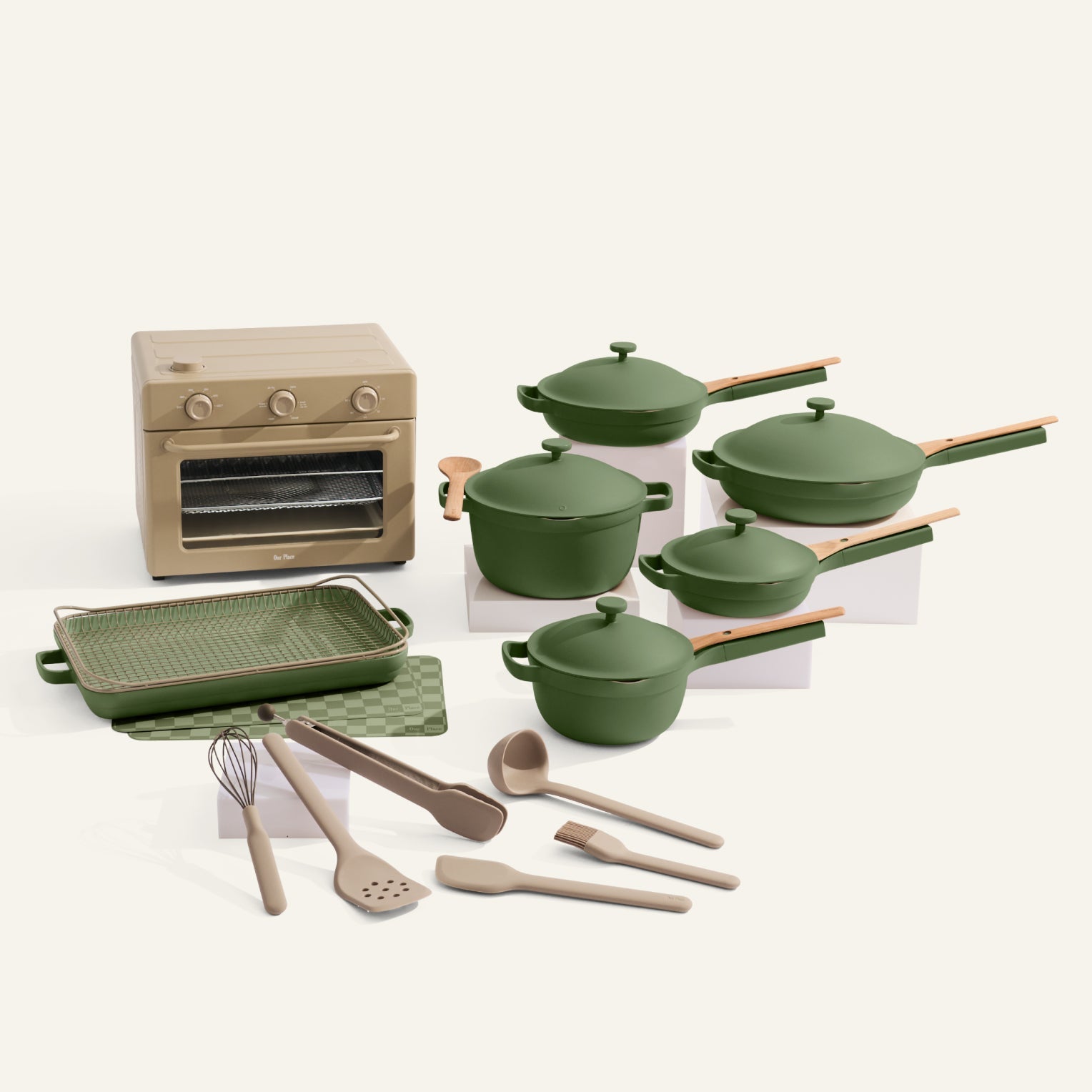 Set of green cookware and kitchen utensils on a white background