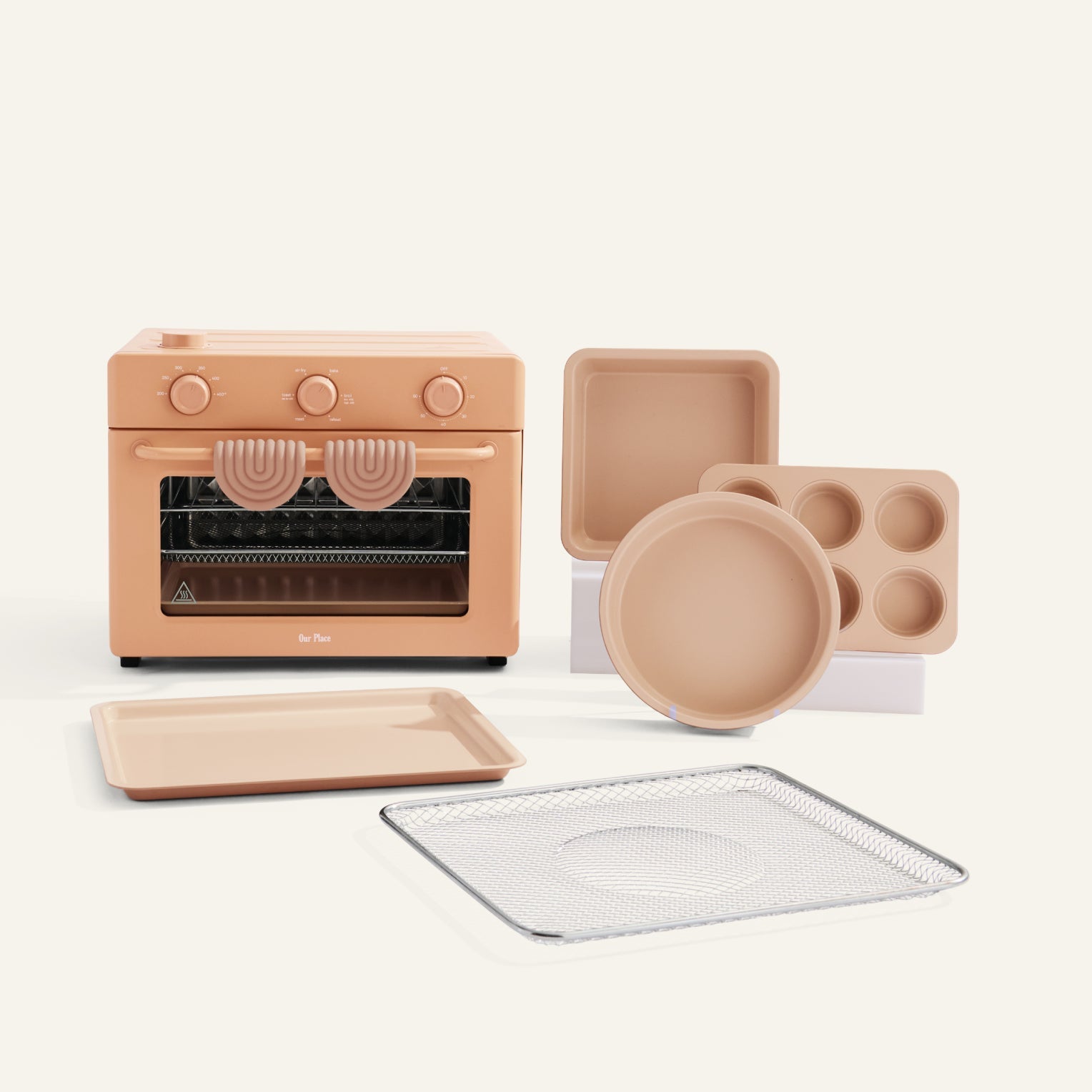 Set of kitchen appliances including an oven, trays, and cookware on a white background