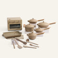 Set of beige cookware including pots, pans, and utensils on a white background